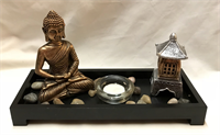 Resin Buddha candle holder with small stone and small pagoda.